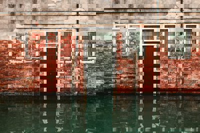 Flood water rising in front of a black front door