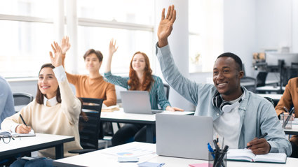Portrait of smiling diverse people of students raising hands at seminar.