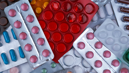 Empty, partially empty and full packs of pills and tablets thrown on top of each other