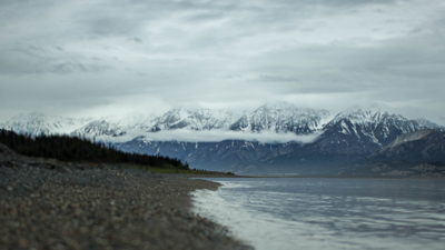 Snow covered mountains with lake in foreground