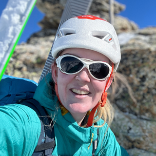 Headshot of person wearing mountain gear.