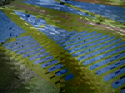 Solar panels in a field, viewed from above