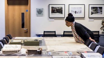 Person looking at maps in RGS Collections.