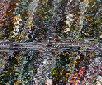 Birds eye view of intersecting highways above a park