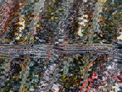 Birds eye view of intersecting highways above a park