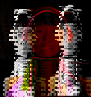 A woman with rings around her neck in order to elongate it
