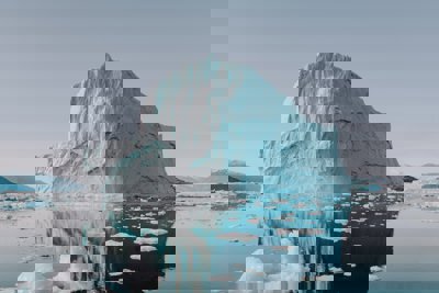 An iceberg in the arctic on a mirror still sea