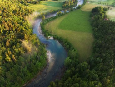 An aerial view of a river showing meanders and flood plains
