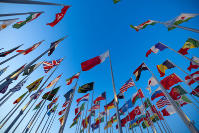 Multiple Flags Flying In Blue Sky