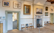 The Main Hall at the Society, showing polar-themed portraits, maps and photographs