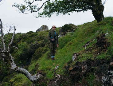 Ted standing amongst moss and trees with video recording equipment
