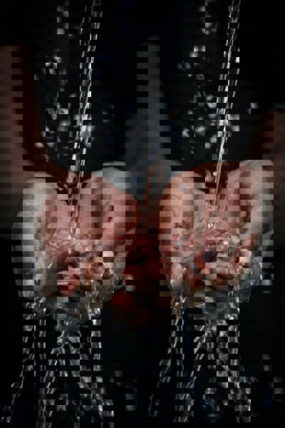 Hands with water running through them