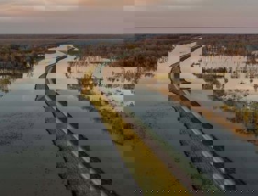 A levee on a river bank that has burst its banks