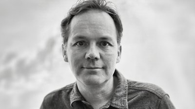 Black and white image of person wearing shirt.