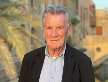Headshot of Michael Palin with bridge in background.