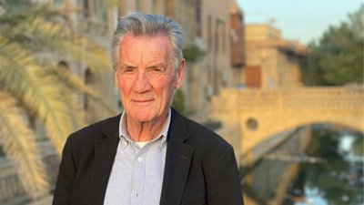 Headshot of Michael Palin with bridge in background.