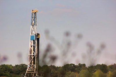 A fracking rig pokes out from above the surrounding trees in Lawrence County, rural Western Pennsylvania.