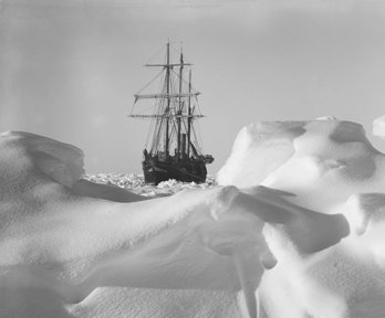 Historical black and white photograph of Endurance frozen in the ice.