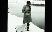 A woman and child stand together amongst a snowy backdrop.