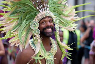 Figure 2: Dancer from the Notting Hill Carnival wearing a green feathered headdress