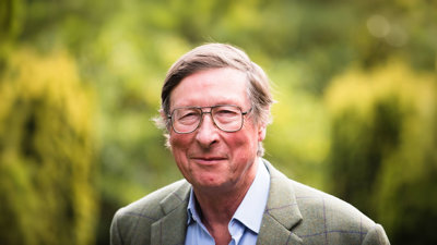 Max Hastings against green backdrop.