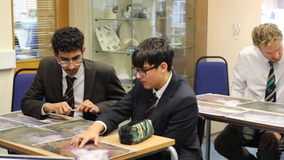 Two students looking at glacier satellite images.