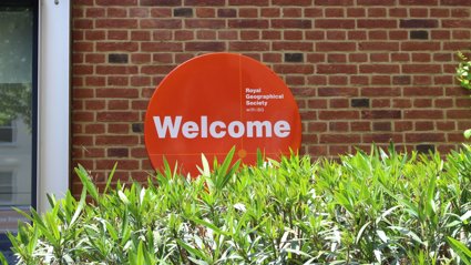 Orange welcome sign that reads Royal Geographical Society with IBG and Welcome.