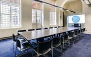 A small meeting room set-up in boardroom style. 