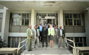 Group of people standing on a set of stairs outside a building posing for a photo.