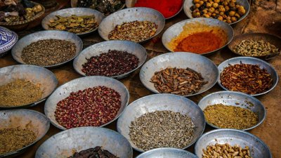 Bowls of spice on a wooden table.