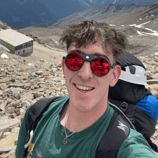 Headshot of Christian Mcmahon-Walsh on mountain.