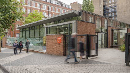 People passing the entrance of the Royal Geographical Society on Exhibition Road.