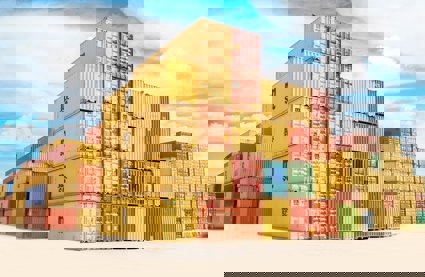 A pile of yellow and orange shipping containers
