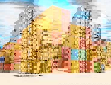 A pile of yellow and orange shipping containers