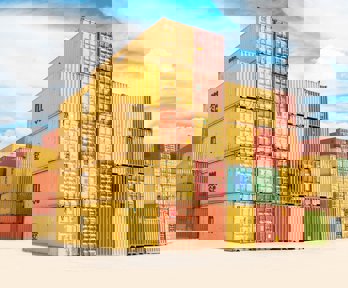 A pile of yellow and orange shipping containers