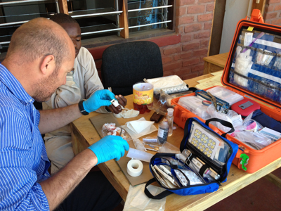 A doctor wraps a plaster around a patients finger