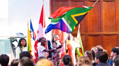 People waving large country flags.