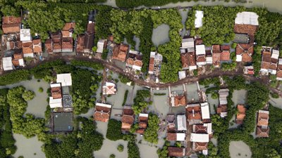 Aerial view of flooded houses. Photograph titled 'Symbiosis'.