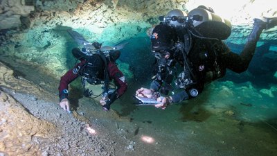 Divers in an underwater cave.