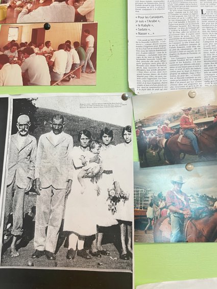 Photograph and newspaper clipping pinned on a noticeboard