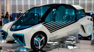 A Toyota hydrogen fuel cell concept vehicle on display at a car showcase.