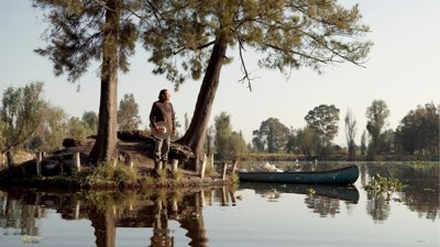 A traditional Chinampero farmer and agroecology teacher on island surrounded by water.