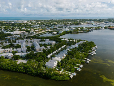 White houses on green reclaimed land near a water course