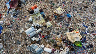 An aerial shot capturing the cluttered expanse of a landfill, showcasing pollution and waste management.