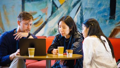 Three people sat discussing at Annual Conference.