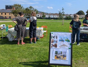 People next to tables during participatory research session.