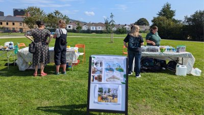People next to tables during participatory research session.