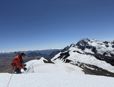 A grant recipients collects snow samples from the summit of a big mountain (Suyuparina in Peru)