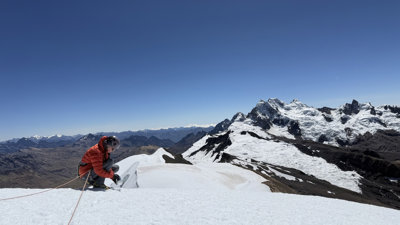 A grant recipients collects snow samples from the summit of a big mountain (Suyuparina in Peru)