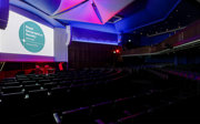 A side-shot of the Ondaatje Lecture Theatre with dark lighting. 